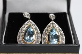 18Y&W diamond and aquamarine drop earrings. Pear shaped aquas bezel set surrounded with pave set