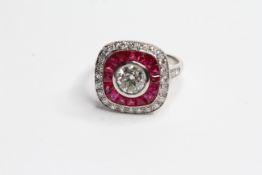Calibre set RUBY and diamond ring. Central brilliant cut in a rub over setting surrounded by