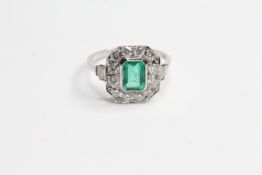 Platinum step cut emerald and diamond ring pave set surround with baguettes at the shoulders E0.90