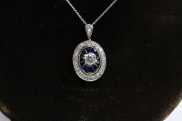 Platinum oval pendant with calibre sapphires and diamonds, central diamond clawset Est 0.75ct (Has