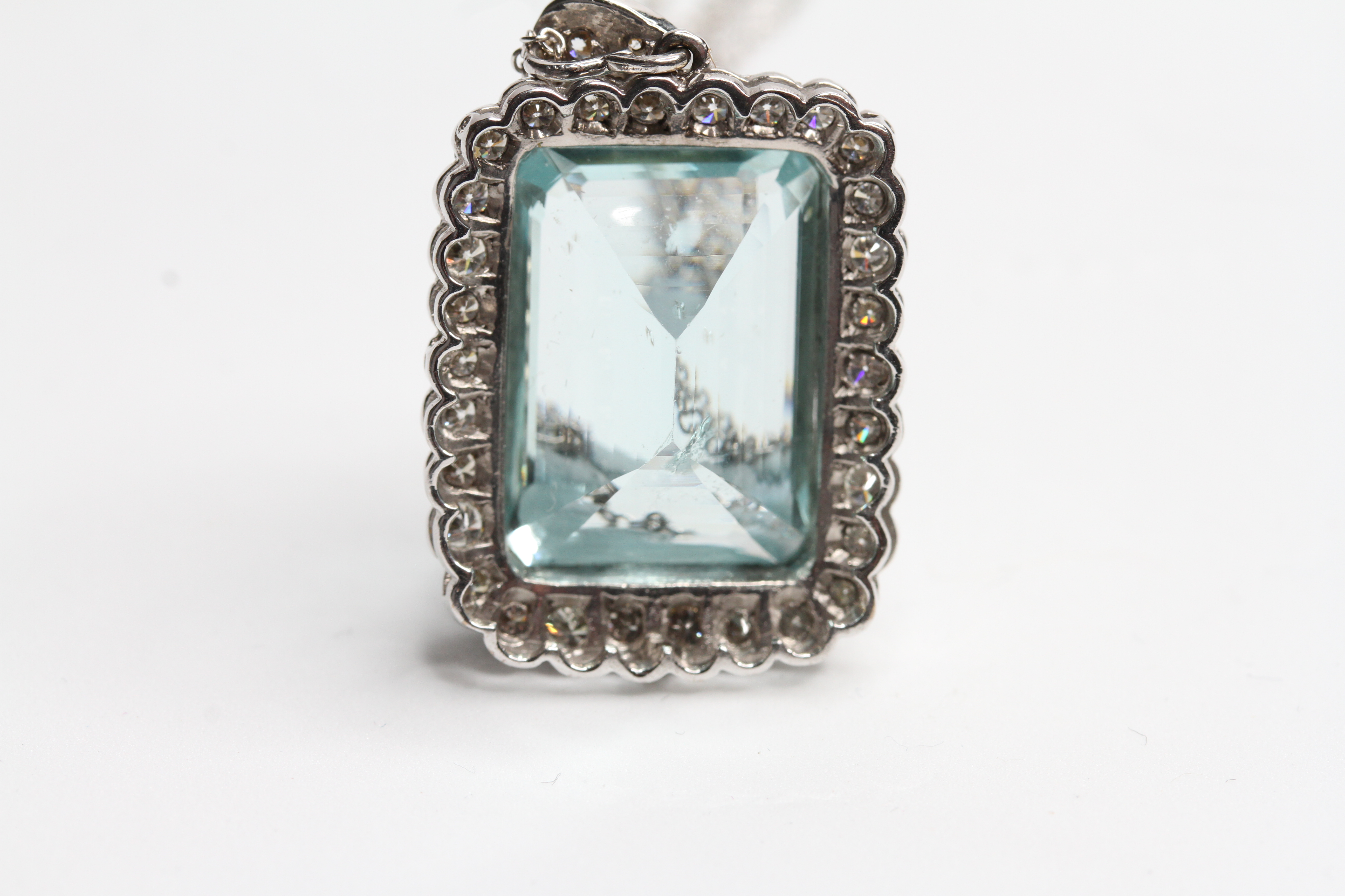 18WG Emerald cut aquamarine in a diamond framed pendant with diamond bale. Aqua 15 carats D1.25 - Image 2 of 2