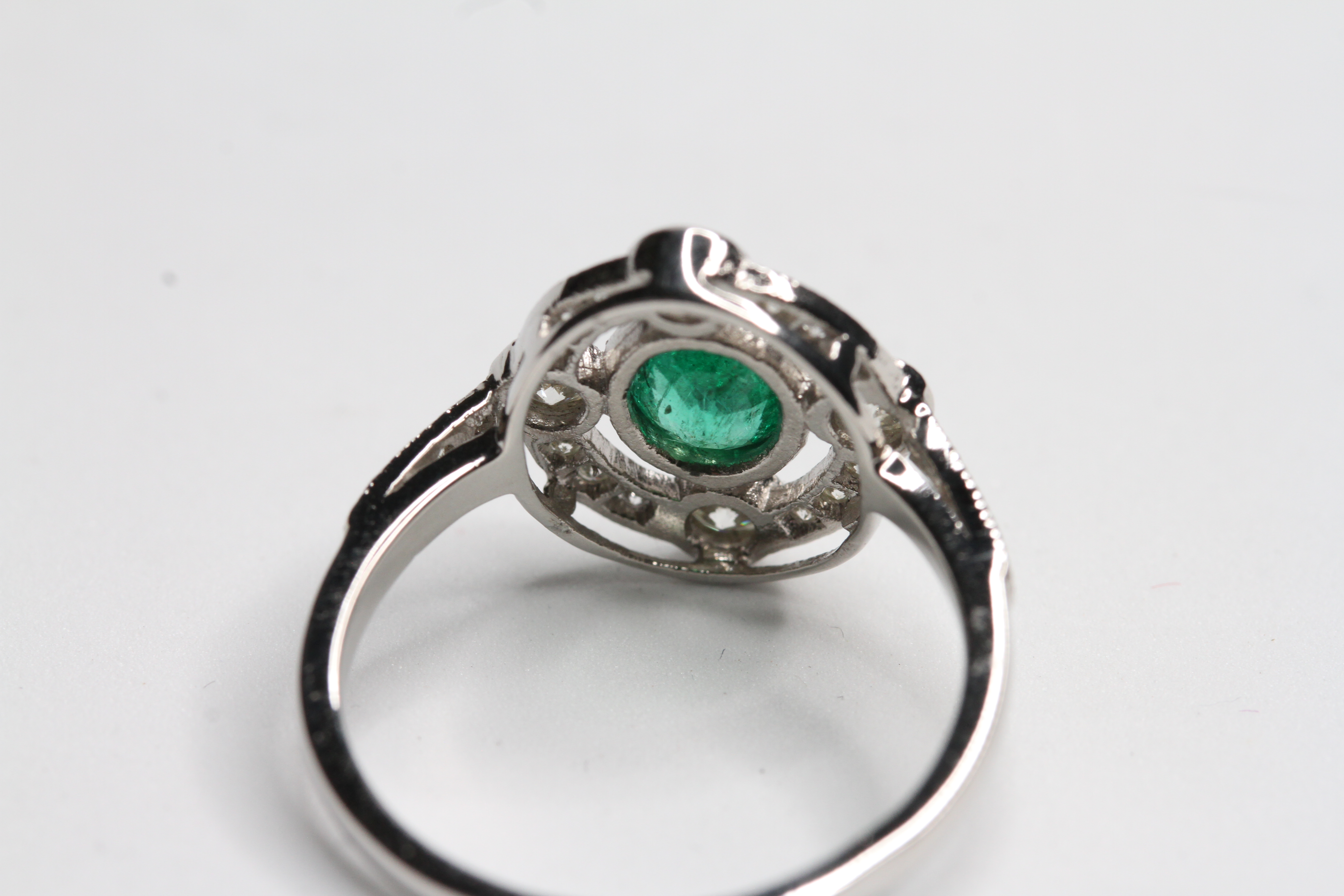 Platinum Oval Emerald and diamond ring with 4 focal point raised bezel set diamond in an open halo - Image 2 of 2