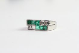 Art Deco Diamond and Emerald Ring, square cut stones, cross over abstract design, mounted in white