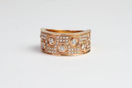 18ct wide band ring with pave set diamonds and diamonds in circle bezels D0.59 stamped inside with