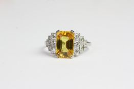 Platinum claw set emerald cut yellow sapphire and diamond deco style ring. YS 4 cts D 0.60 carats in