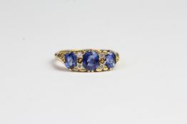 18ct Carved half hoop ring with 3 sapphires and 4 small diamonds. Hallmark present. Ring size M