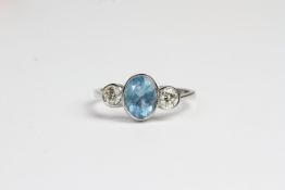 Platinum bezel set aquamarine and diamond 3 stone ring. A1.10 ct D 0.40 cts in total Ring Size N