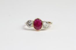 18ct Bezel set oval ruby and round brilliant diamond 3 stone ring. Diamonds are set in white gold