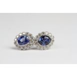 18ct Oval bezel set sapphire and diamond cluster earrings with openwork. Large double loop earring