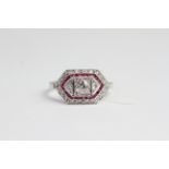 18ct Calibre set ruby and diamond ring with raised centre square collet housing a round brilliant