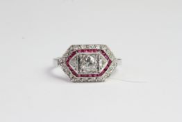 18ct Calibre set ruby and diamond ring with raised centre square collet housing a round brilliant