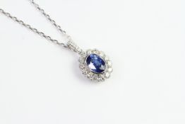 18ct bezel set oval sapphire and diamond cluster pendant on an 18WG chain 42cm/16 inches. S1.75ct