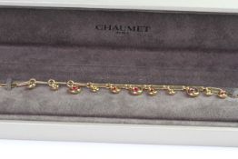 Chaumet gold bracelet with, pink, red, yellow and orange droop stones. comes with Chaumet box.