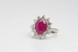 18 carat white gold oval ruby and diamond cluster ring. Ruby 2 carats estimated, Diamonds, 1 carat