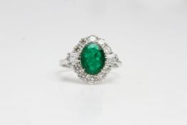 18ct white gold Emerald and Diamond cluster ringwith fanned baguettes above the shoulders of