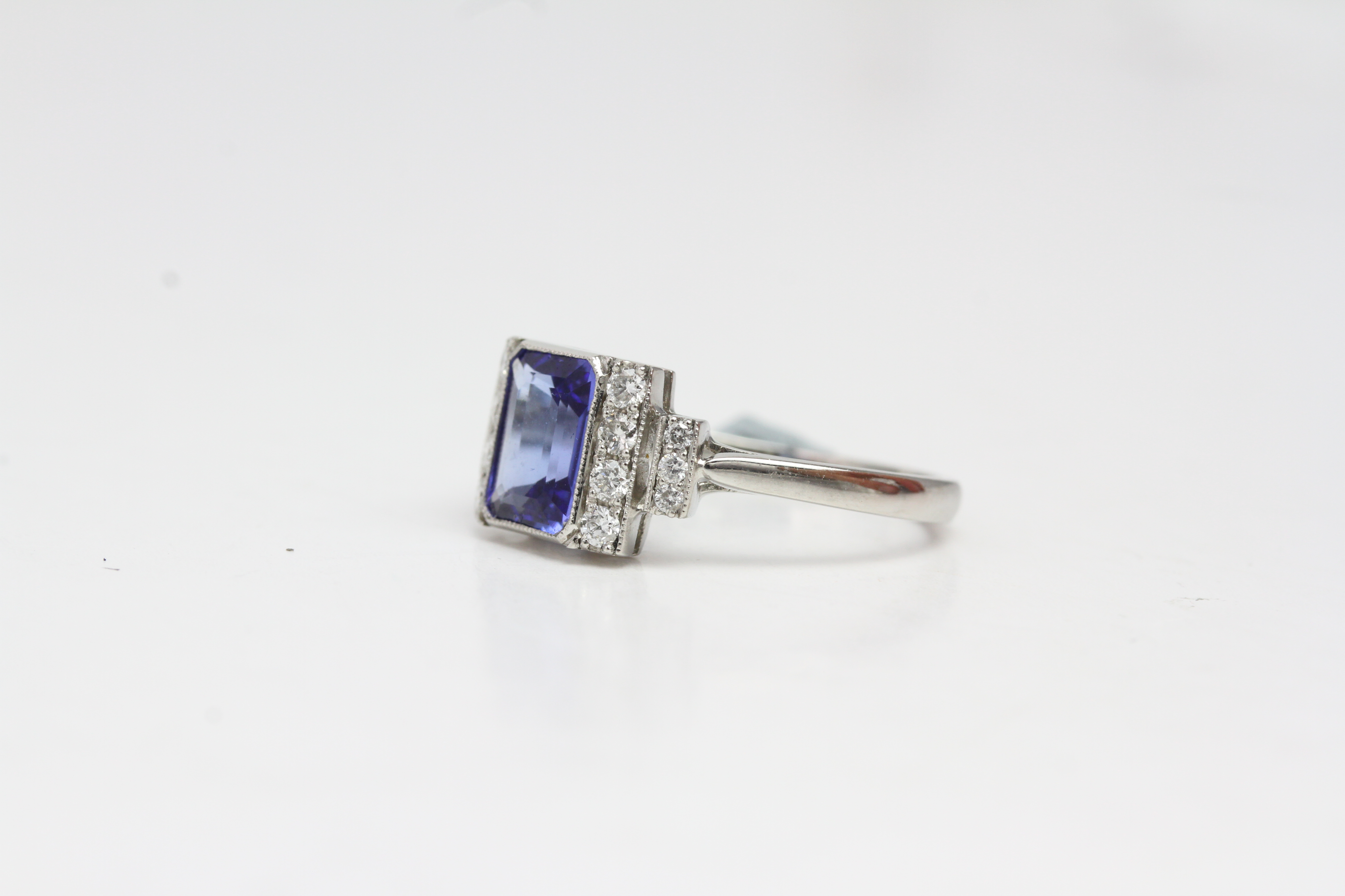 Platinum Tanzanite and diamond ring. Mille grainedged bezel set step cut tanzanite with - Image 2 of 3