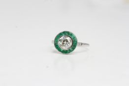 18 carat white gold emerald and diamond target ring centre is estimated 0.90 cts
