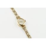 ACCURIST 9CT GOLD COCKTAIL WATCH, oval silver dial with hour markers and hands, 15mm 9ct gold case