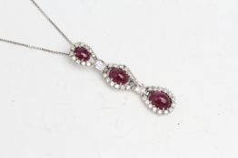 18 carat white gold pendant with 3 clusters of cabochon ruby and diamond, 2 x oval beryls separating