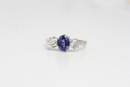 Platinum Oval Sapphire and brilliant cut diamond 3stone ring, claw set in platinum. S1ct D0.60ct