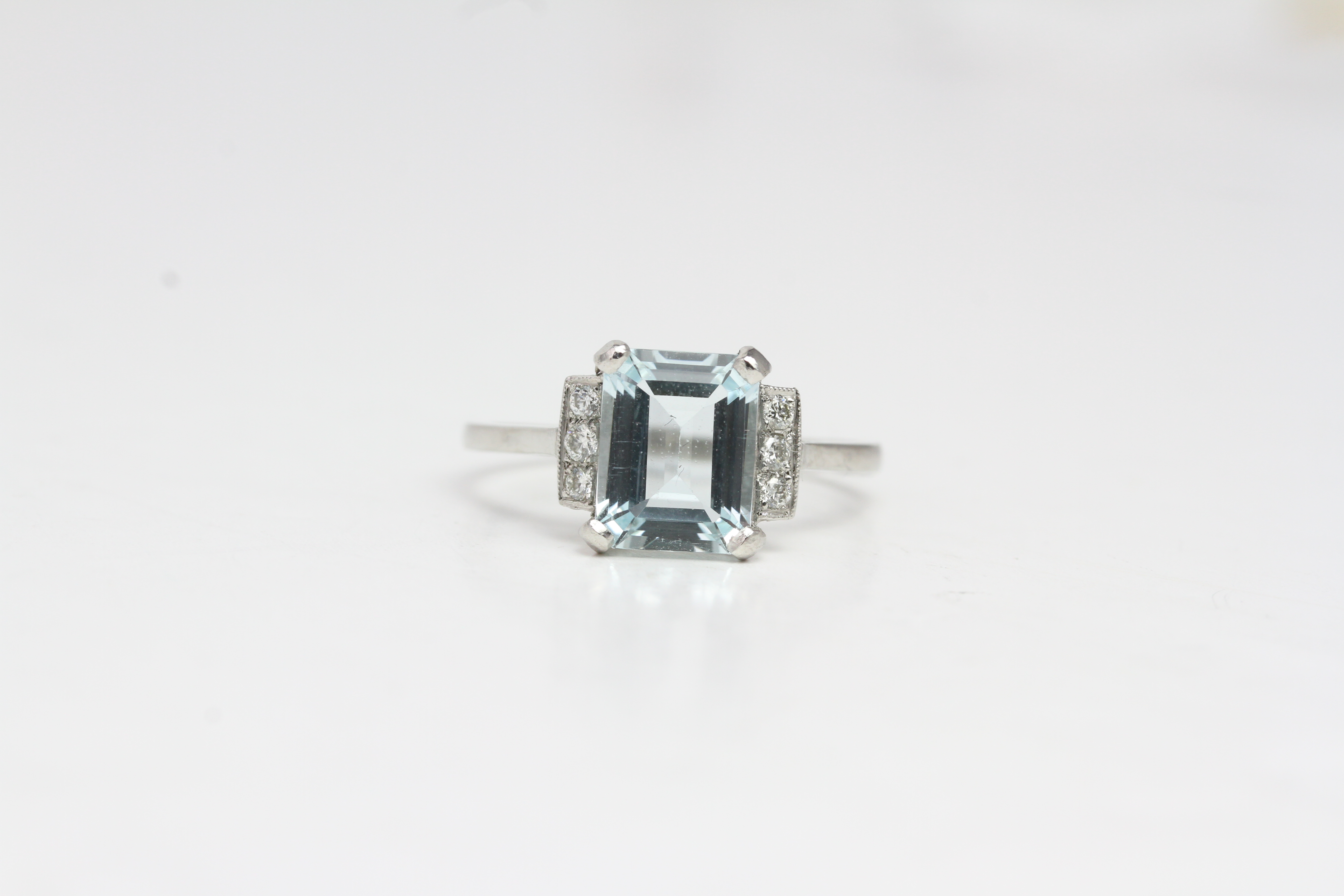 Platinum aqua and diamond ring. A Step cut aquawith 3 diamonds in each shoulder panel.A2cts D0.