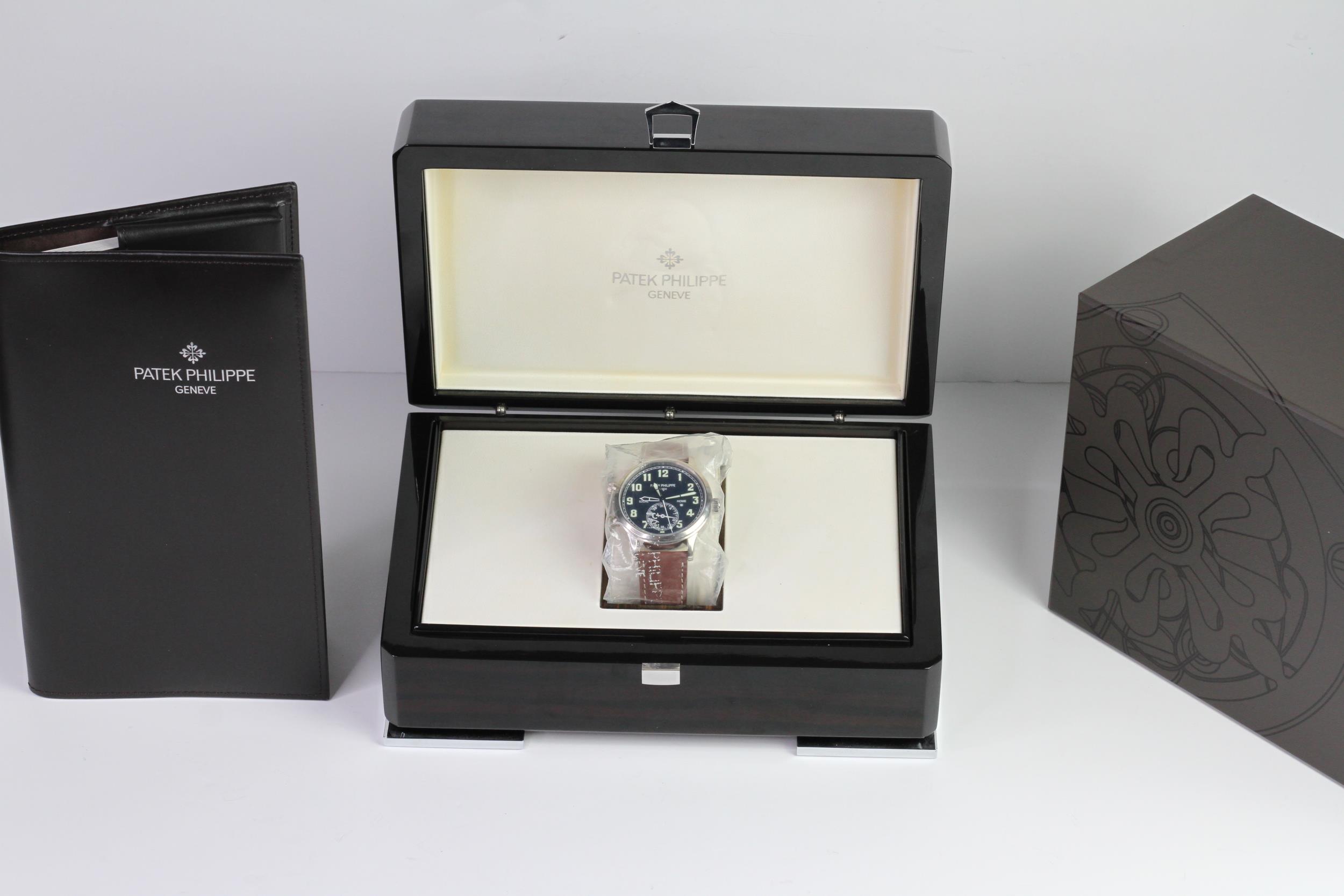 A FINE PATEK PHILIPPE CALATRAVA PILOT TRAVEL TIME REFERENCE 5224G-001, SEALED FROM SERVICE, WITH BOX