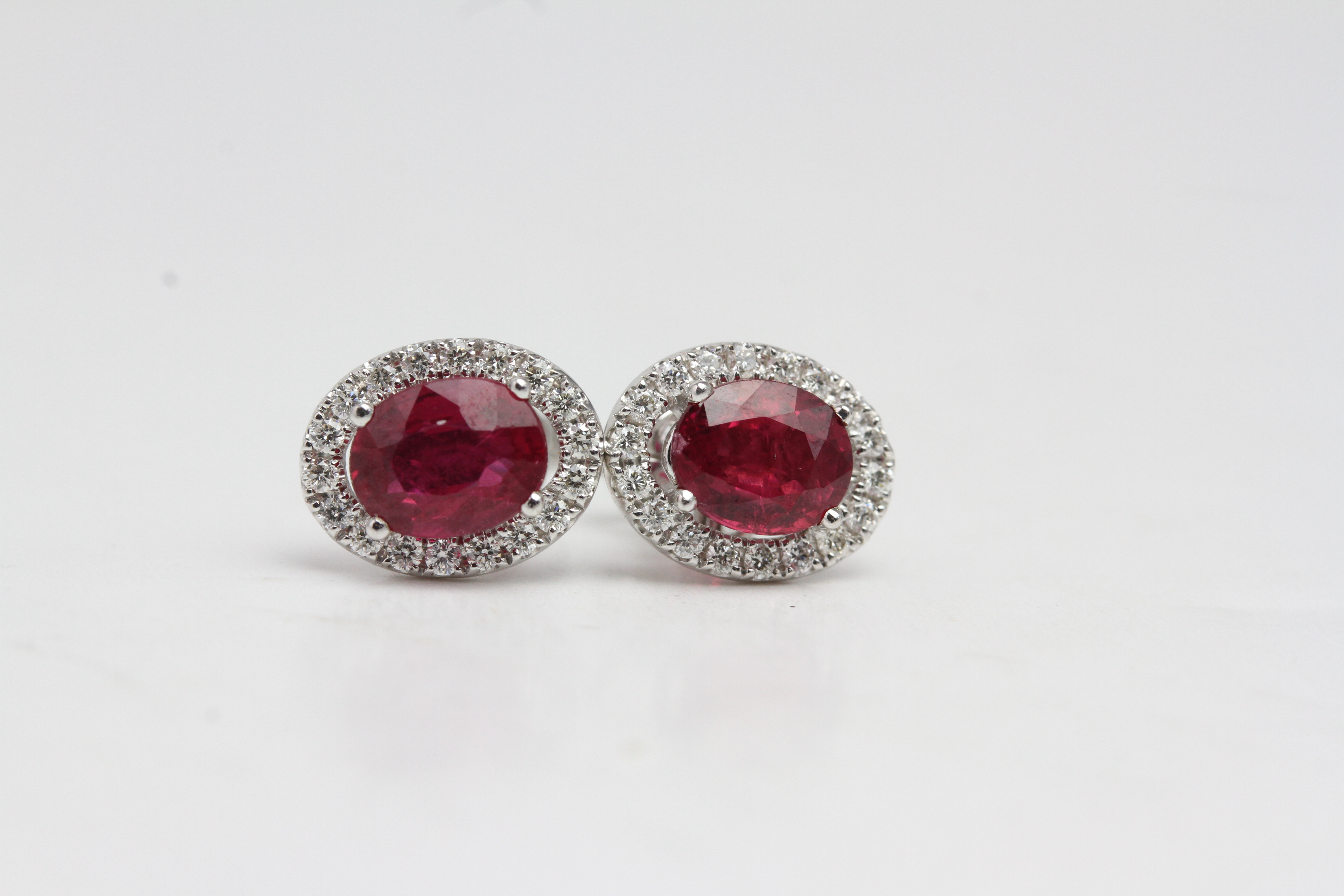 18 carat white gold ruby and diamond cluster earrings Ruby 1.50 carats in total Diamond 0.22