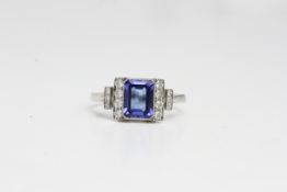 Platinum Tanzanite and diamond ring. Mille grainedged bezel set step cut tanzanite with