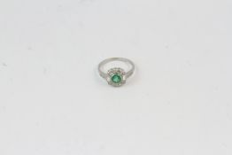 Platinum Round emerald and diamond cluster ring with baguettes E0.70 D0.25