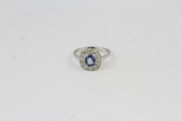 Platinum oval sapphire and diamond cluster ring S1.20 D0.50