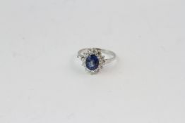 18WG oval sapphire and diamond cluster ring. S2.10 D0.85 with baguettes to the tip of the shoulder