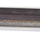 Chaumet gold bracelet with, pink, red, yellow and orange droop stones. comes with Chaumet box.
