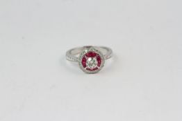 18WG ruby and diamond target ring central diamond 0.49 carats detailed diamond shoulders
