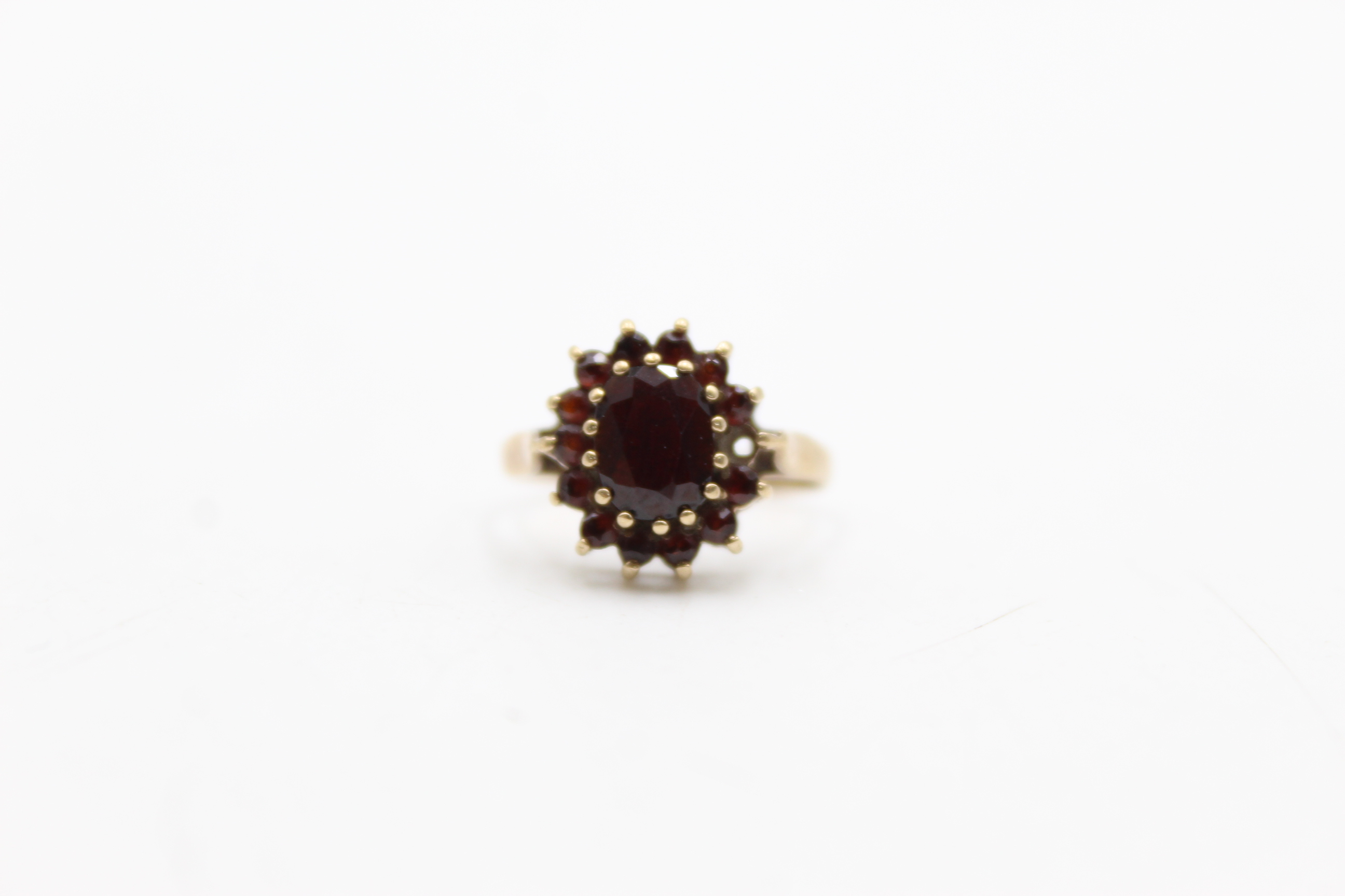 9ct gold garnet halo set ring, as seen (2.5g)