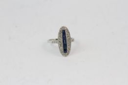 18WG vintage oval shaped ring with a central row of step cut sapphires