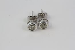 Pair of white gold bezel set round brilliant diamond studs with flower shaped butterflies