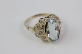 A yellow gold oval aqua and diamond ring