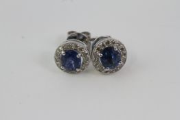 White gold a pair of round sapphire and diamond earrings with generous disc butterflies.