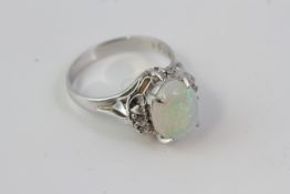 Marked PT900 this cabochon Opal and diamond ringalso