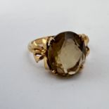 Fine 9CT gold smoky quartz ring. Fully hallmarked for 9CT gold detailed with bows on either side