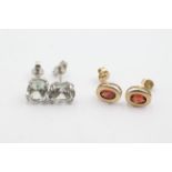 2 x 9ct gold quartz & garnet stud earrings . Weighs 3 grams. The quartz earrings measure 8mm in