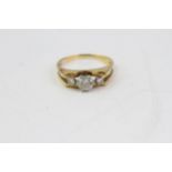 find 18 CT gold 50 point three stone diamond ring. Set in an 18 Karat yellow gold shank with a