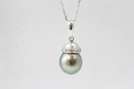 Tahitian pearl and diamond pendant. The bale is mark 18K on the inside. The chain is 16 inches and