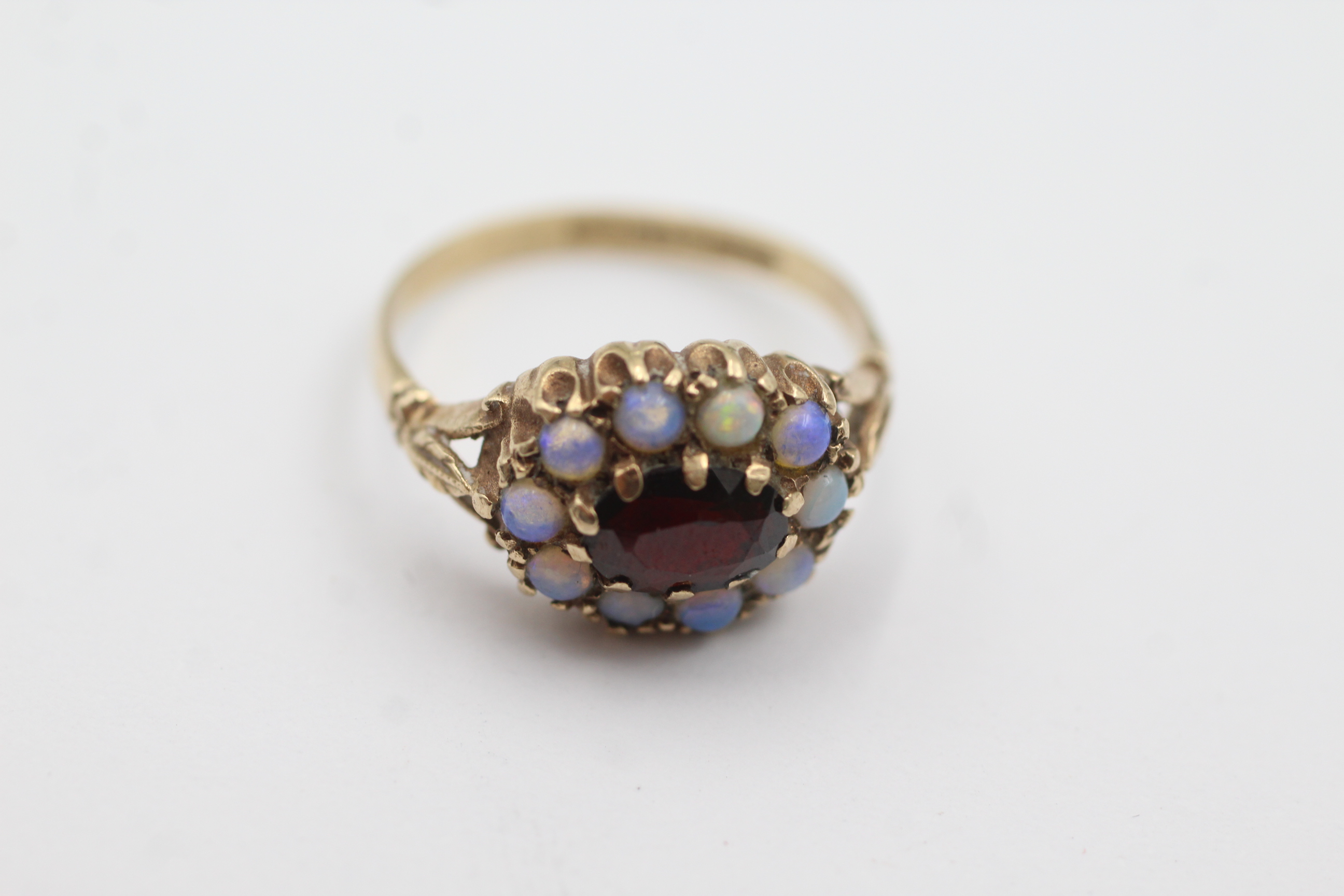 9ct gold opal and garnet dress ring weighs 2.5 grams. Fully hallmarked for 9ct gold. Uk size. N