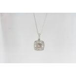 A filigree diamond pendant stamped with 0.35, 18K and 750 on a 16 inch 9ct white gold chain.