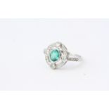 Oval emerald and diamond ring with 4 prominent set diamonds. Emerald 0.70 carats platinum