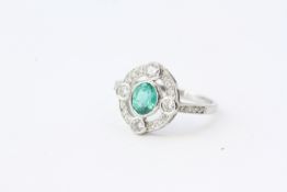 Oval emerald and diamond ring with 4 prominent set diamonds. Emerald 0.70 carats platinum