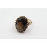 9ct gold smokey quartz ornate framed ring - weighs 6.7 grams. Uk size L. The head of the ring