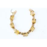 A 1960’s Citrine bracelet comprising 7 step cut citrines inclaw set collets all equally spaced on