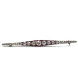 Antique Art Deco platinum french diamond and calibre cut ruby bar brooch . Marked with an owl on